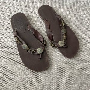KORS Michael Kors brown leather flip flop sandals with bronze metal detailing